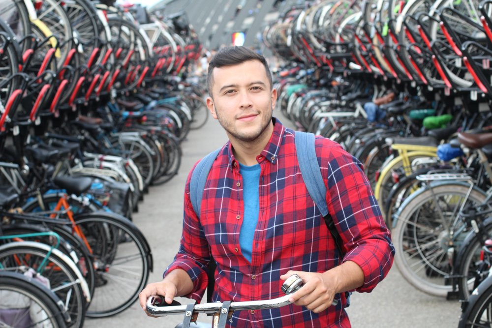 Ethnic,man,in,bicycle,3d,parking,lot