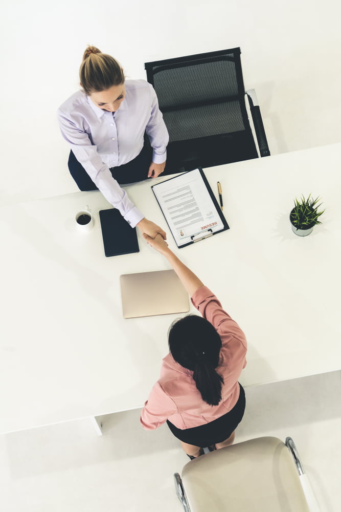 Two,young,business,women,in,meeting,at,office,table,for