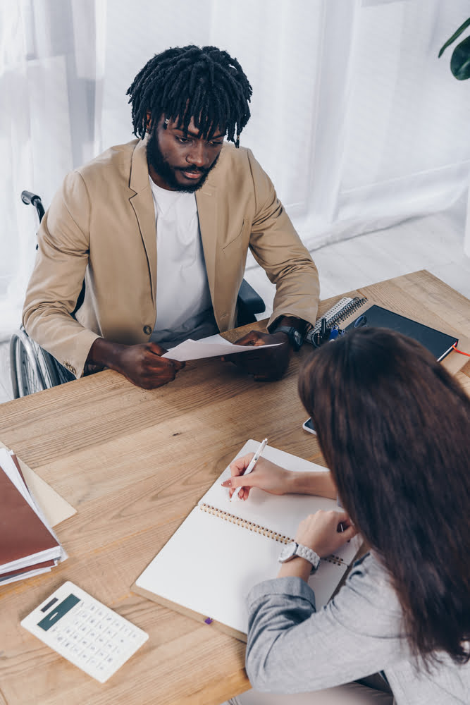 High,angle,view,of,african,american,disabled,recruiter,holding,papers