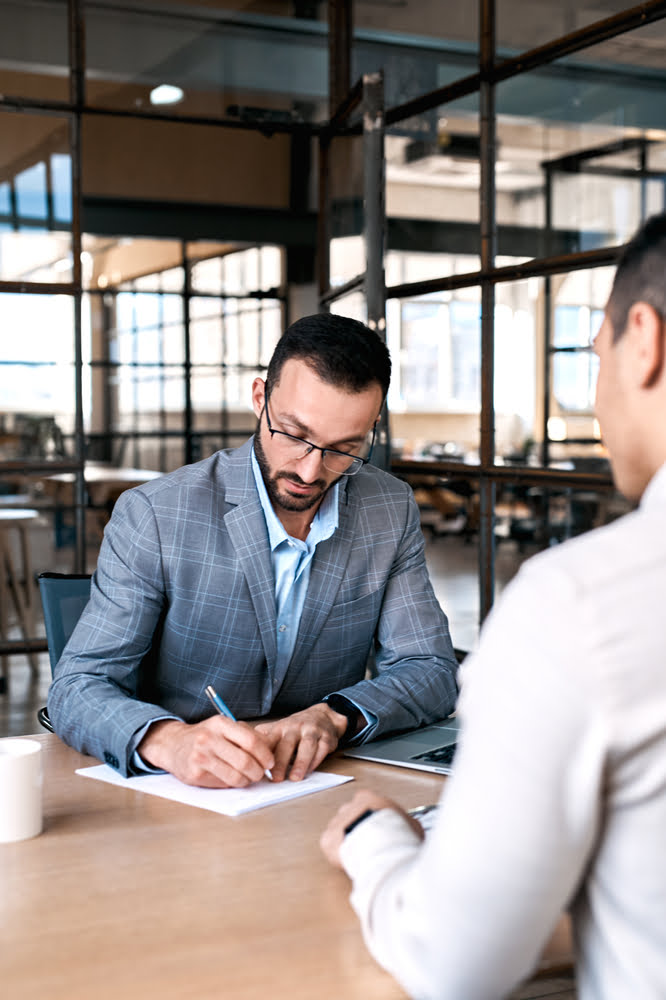 Two,men,manager,taking,notes,concentrated,on,job,candidate,sitting