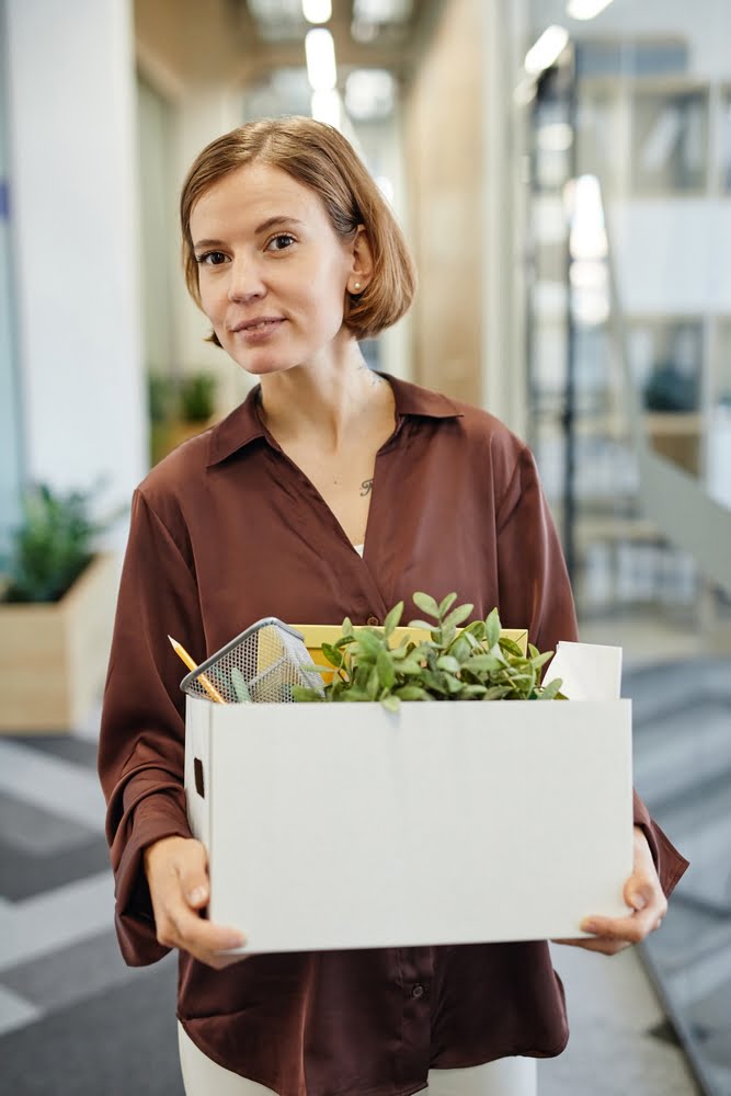 Vertical,waist,up,portrait,of,young,woman,holding,box,with